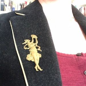 Brass-tone Art Nouveau tambourine player brooch